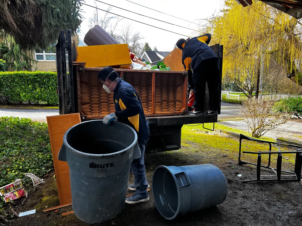 99 Junk Removal crew loading a truck on a Puget Sound cleanout