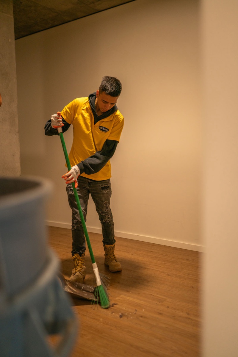 99 Junk Removal crew sweeping the space clean after a haul