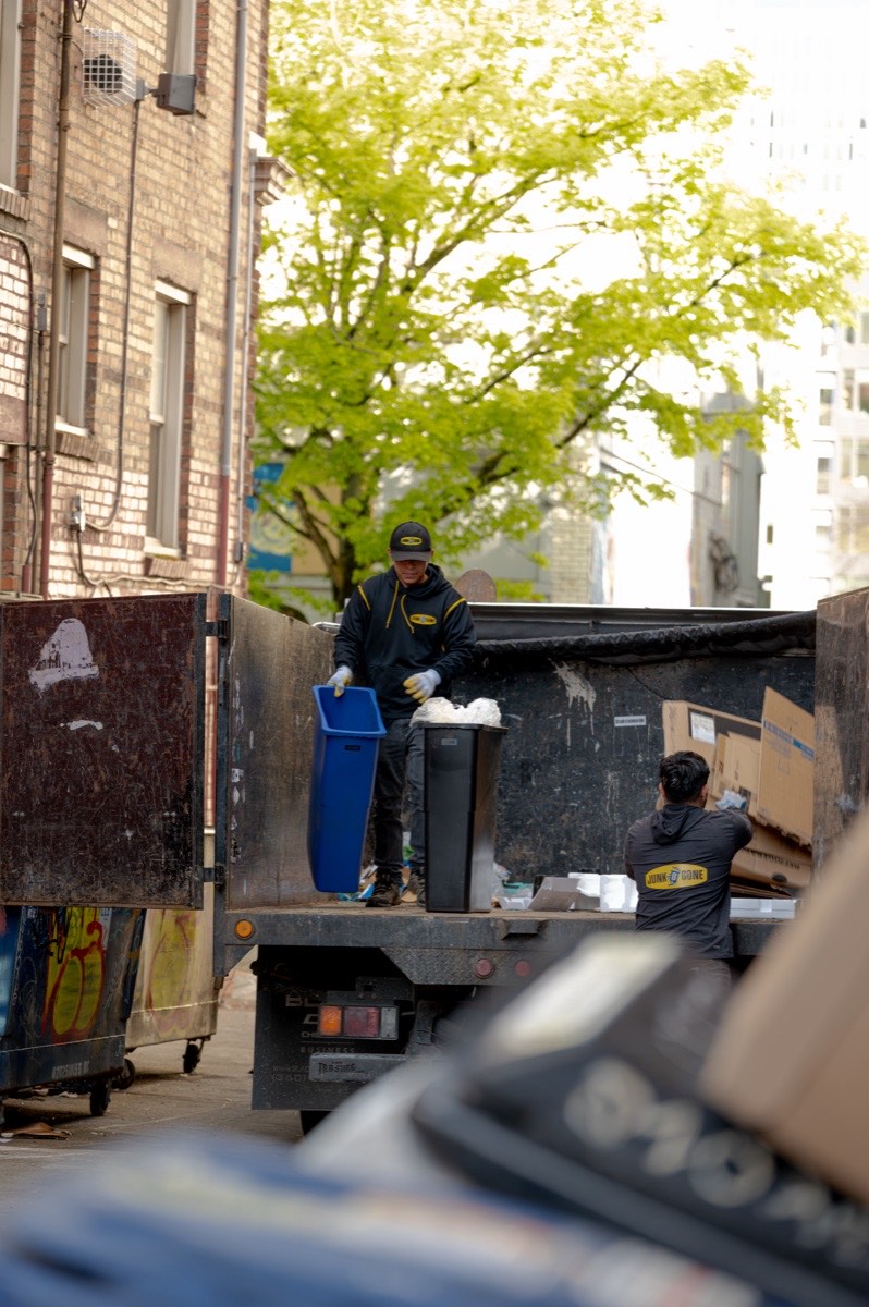 99 Junk Removal crew sorting a load for recycling and donation