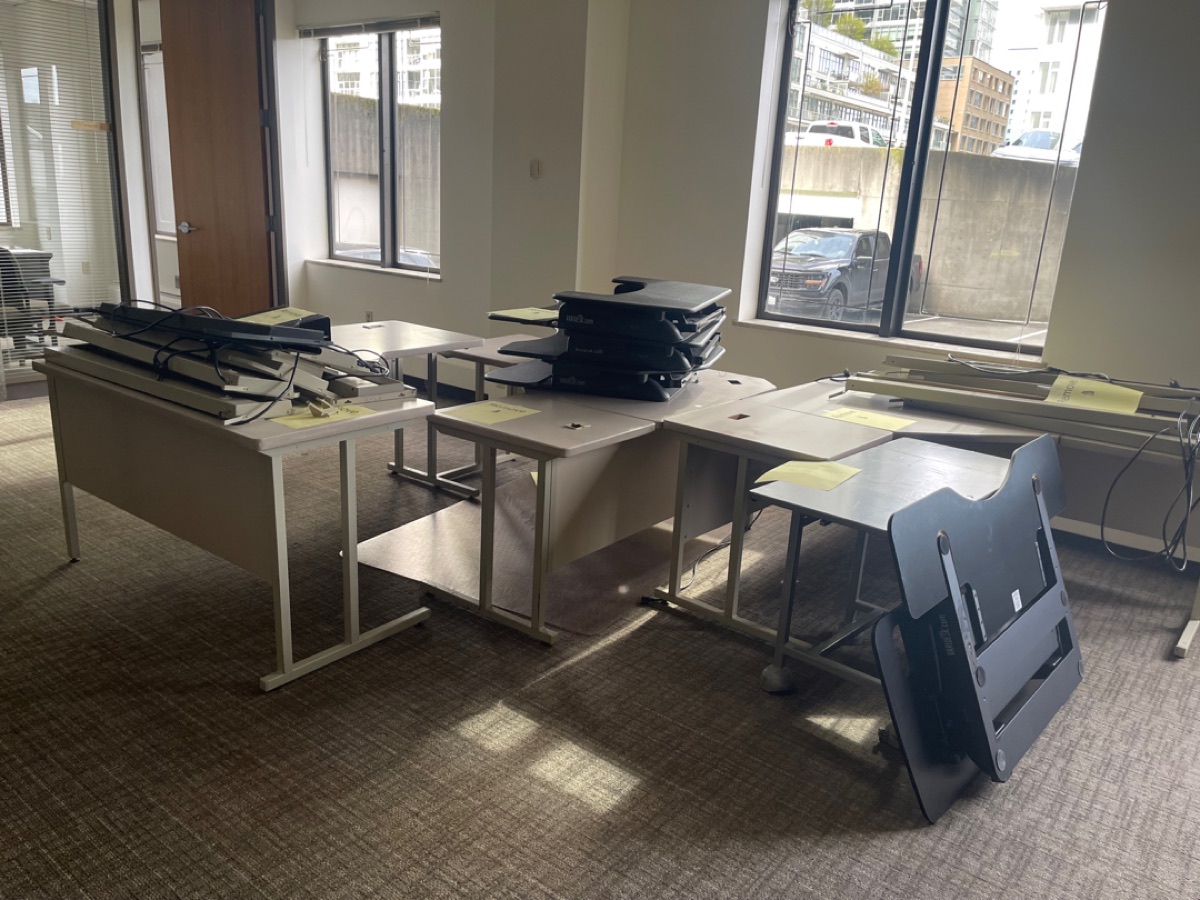 Office full of desks, monitors, and equipment before a 99 Junk Removal cleanout