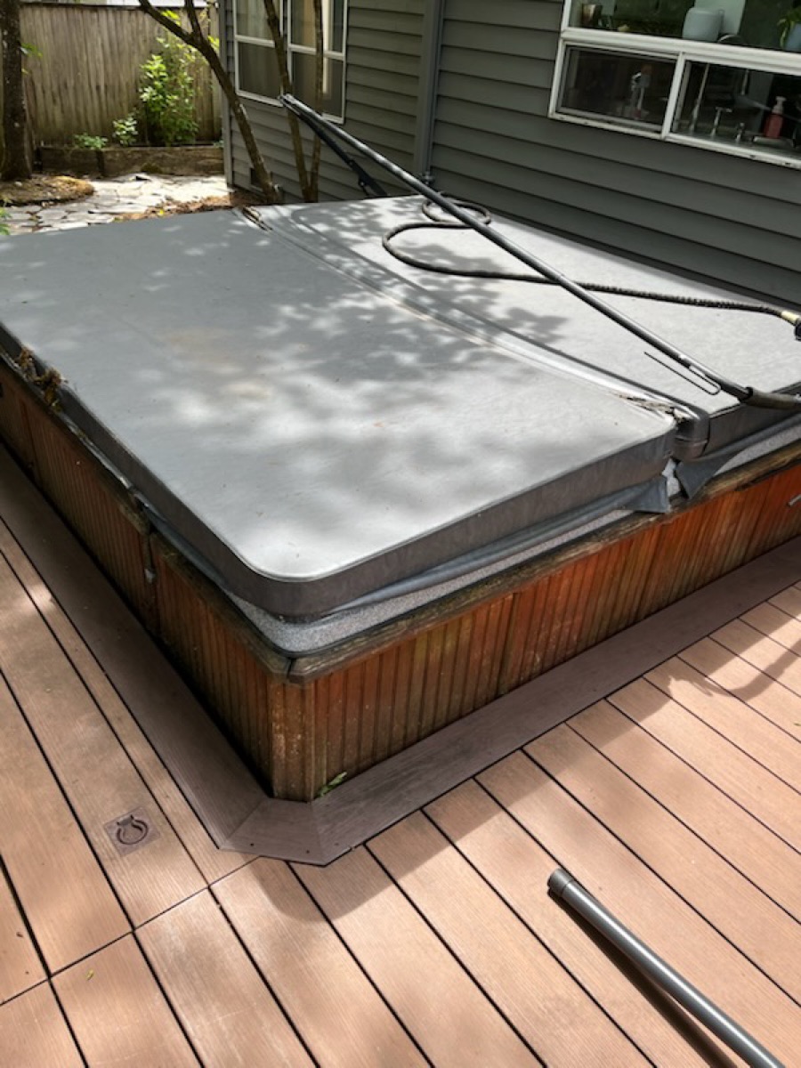 Before: covered in-ground hot tub on cluttered deck