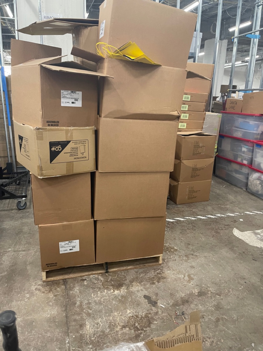 Pallets of commercial inventory and shipping boxes staged in a warehouse